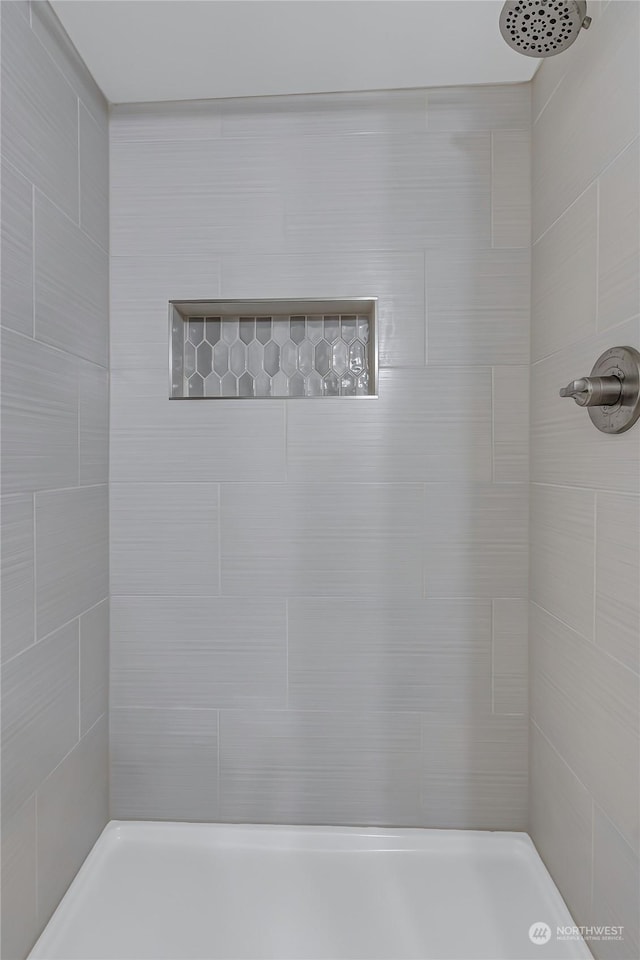 bathroom with tiled shower