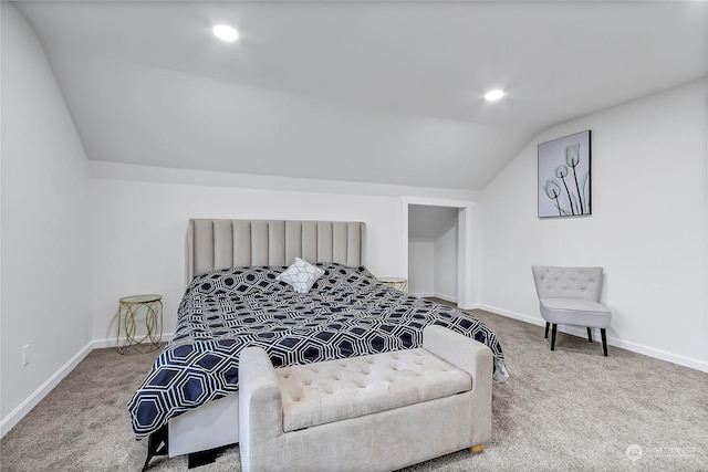 carpeted bedroom with lofted ceiling