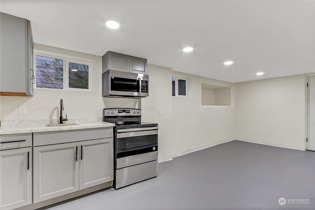 kitchen with sink, gray cabinets, and stainless steel appliances