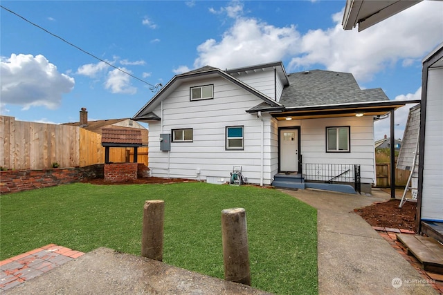 rear view of house with a lawn