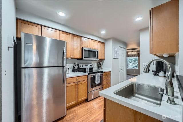 kitchen featuring sink, light hardwood / wood-style floors, and appliances with stainless steel finishes