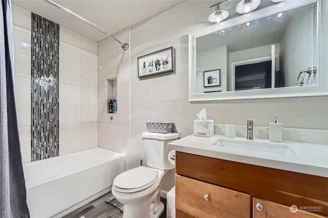 full bathroom featuring hardwood / wood-style flooring, vanity, toilet, and shower / tub combo