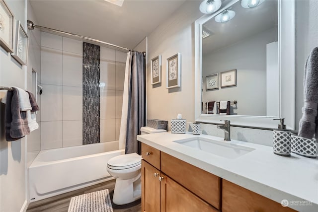 full bathroom featuring vanity, hardwood / wood-style floors, shower / bath combo, and toilet