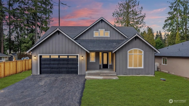 modern inspired farmhouse featuring a yard and a garage