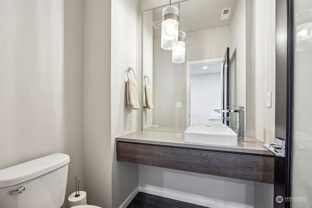 bathroom with toilet and vanity