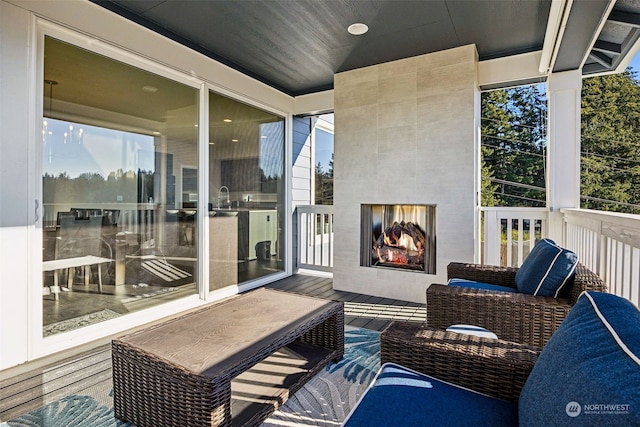 balcony featuring sink and a tile fireplace