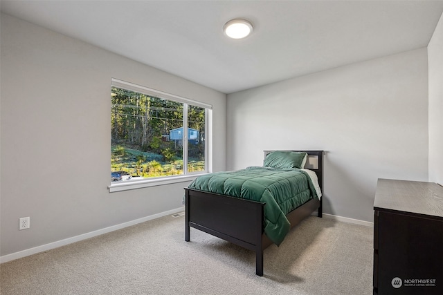 bedroom featuring light colored carpet