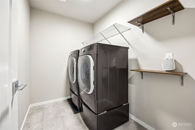 clothes washing area with washing machine and clothes dryer