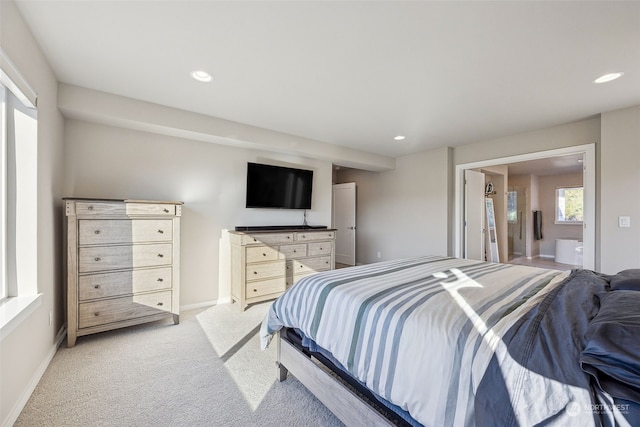 carpeted bedroom featuring connected bathroom