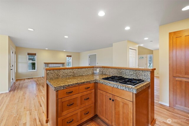 kitchen with light wood-type flooring and stainless steel gas cooktop