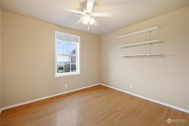 empty room featuring hardwood / wood-style flooring and ceiling fan