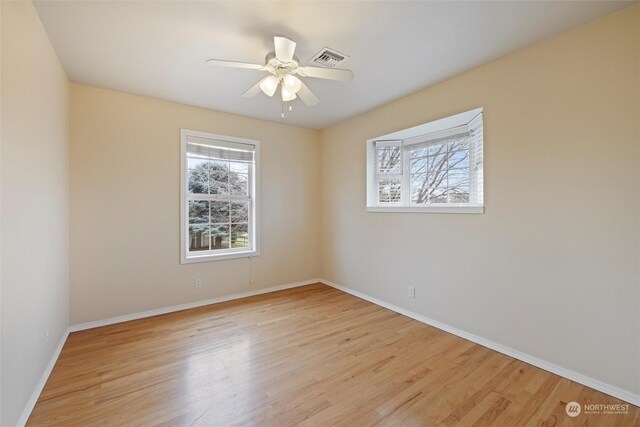 spare room with ceiling fan, light hardwood / wood-style flooring, and plenty of natural light