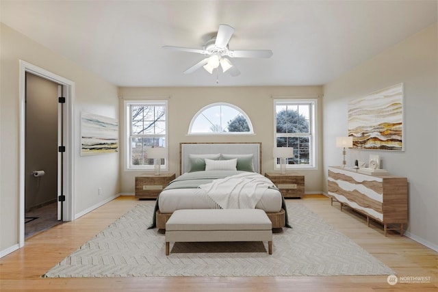 bedroom with ceiling fan and light hardwood / wood-style flooring