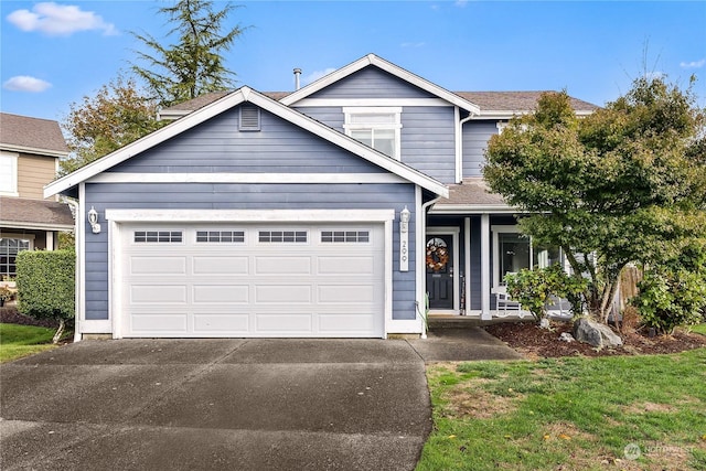 view of front of home featuring a front lawn and a garage