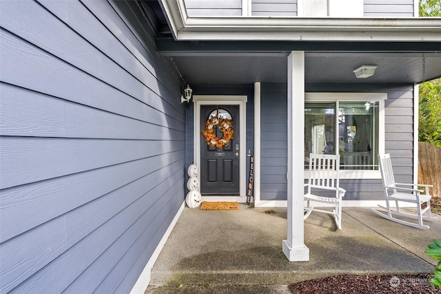 view of exterior entry featuring a porch