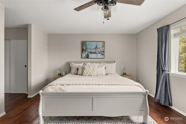 bedroom with ceiling fan and dark wood-type flooring