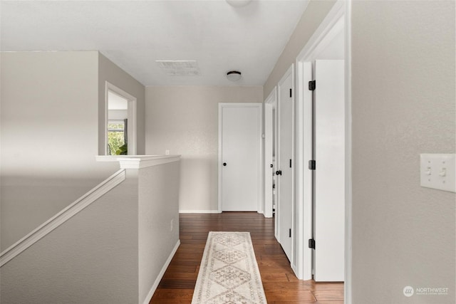 corridor with hardwood / wood-style floors