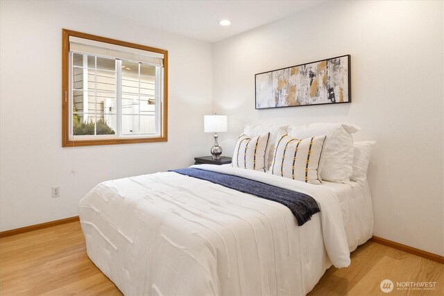 bedroom featuring baseboards, wood finished floors, and recessed lighting