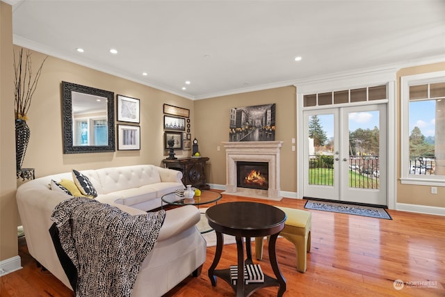 living room featuring french doors, crown molding, and wood-type flooring