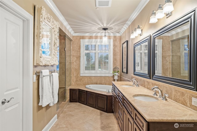 bathroom featuring tile patterned flooring, tile walls, ornamental molding, vanity, and a bathtub