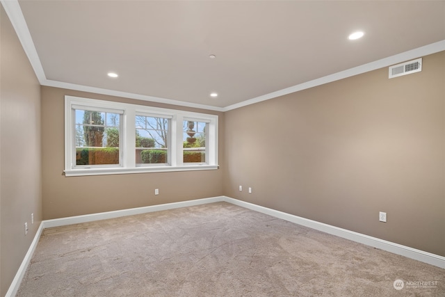 unfurnished room featuring ornamental molding and light carpet