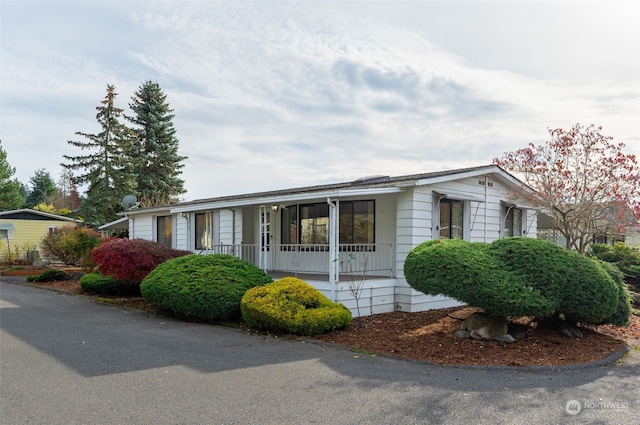 view of property exterior featuring covered porch