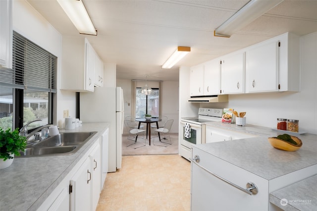 kitchen with white cabinets, a notable chandelier, sink, and white appliances