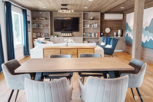 interior space with wood ceiling, a wall unit AC, wood walls, and light hardwood / wood-style floors