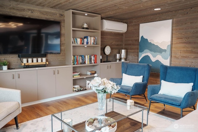 living area with a wall mounted AC, wood walls, wooden ceiling, light wood-type flooring, and built in shelves