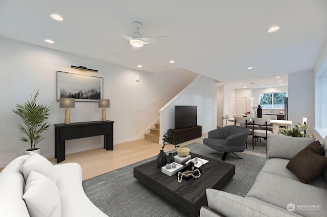 living room with light wood-type flooring and ceiling fan