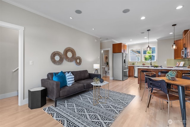 living room with ornamental molding and light wood-type flooring