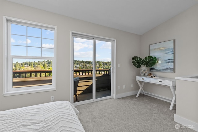 carpeted bedroom with lofted ceiling and access to outside