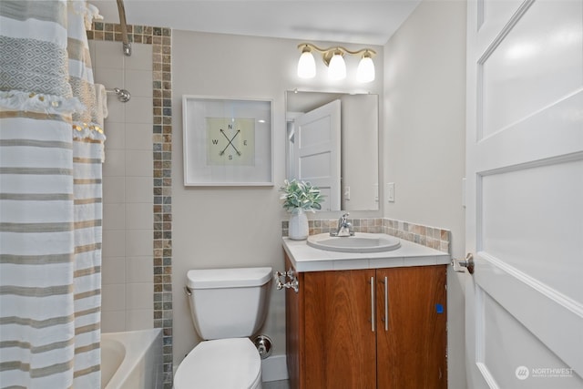 full bathroom with vanity, shower / tub combo, and toilet