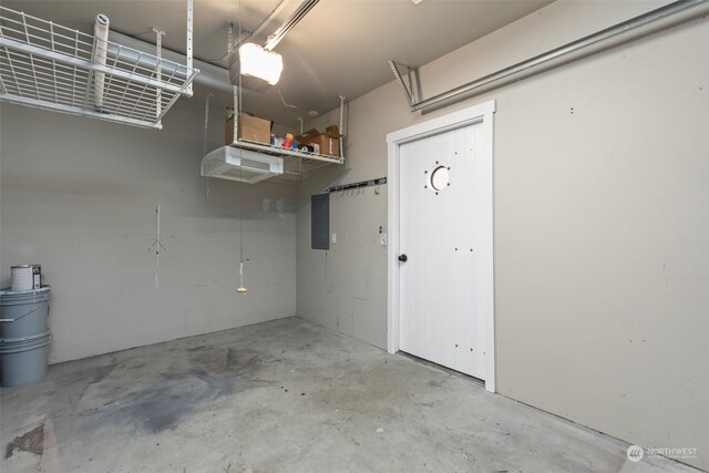 garage featuring a garage door opener and electric panel