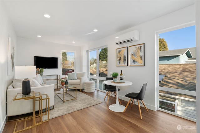 living room featuring hardwood / wood-style floors and a wall mounted air conditioner