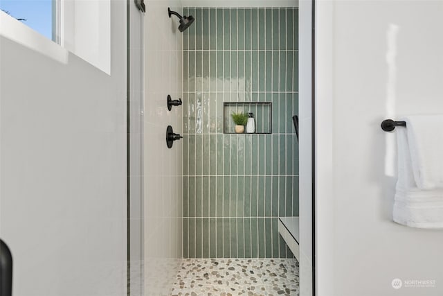 bathroom with tiled shower