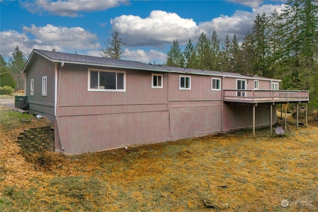 rear view of property with a wooden deck