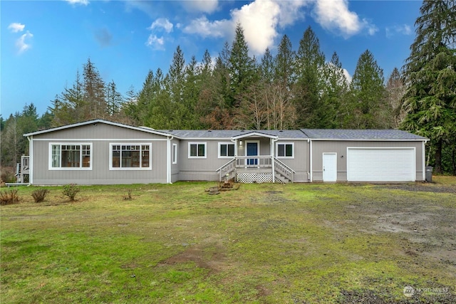 view of front of property with a front lawn and a garage