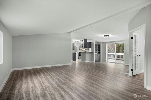 unfurnished living room with dark hardwood / wood-style floors and lofted ceiling