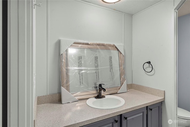 bathroom featuring toilet and vanity