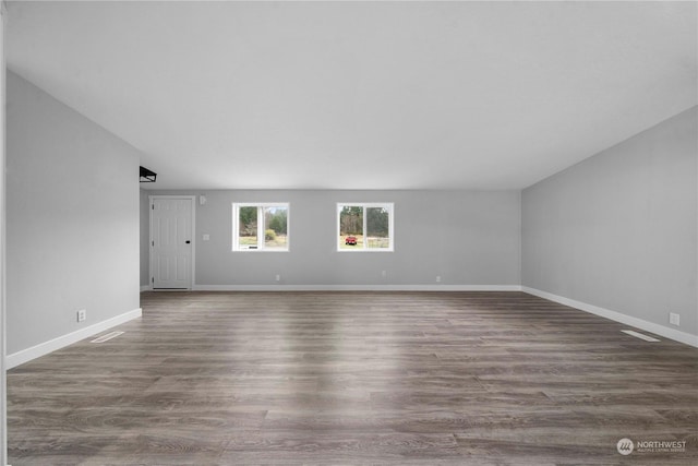 unfurnished room with dark hardwood / wood-style floors