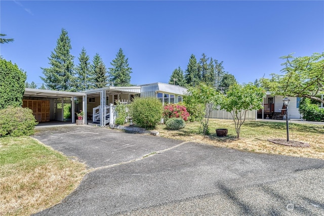 ranch-style house with a front lawn and a carport