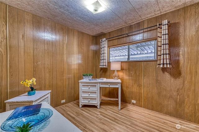 office with hardwood / wood-style floors, wood ceiling, and wood walls