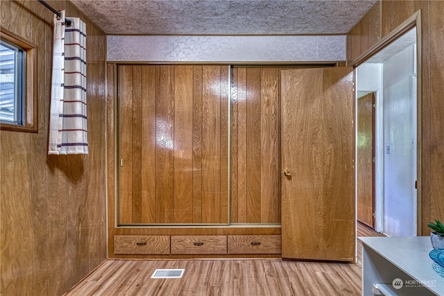 interior space featuring hardwood / wood-style flooring and wood walls