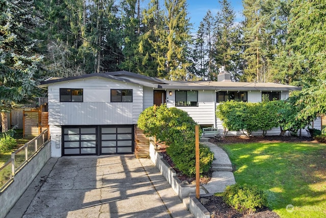 view of front of house with a garage and a front lawn