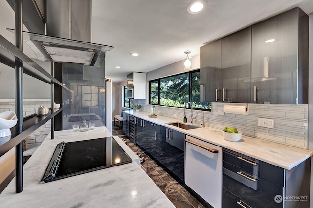 kitchen featuring dishwasher, sink, island exhaust hood, light stone counters, and black electric cooktop