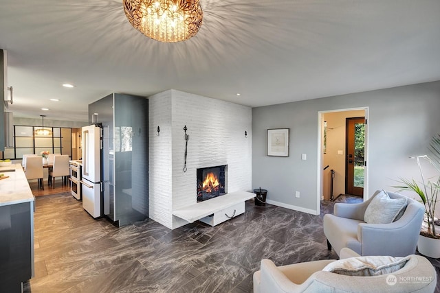 living room with a brick fireplace