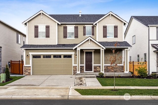 craftsman-style home featuring a garage and a front lawn