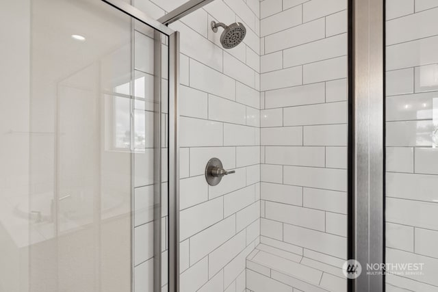 bathroom featuring a shower with door