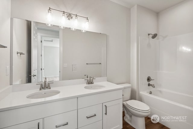 full bathroom featuring toilet, vanity, wood-type flooring, and shower / washtub combination